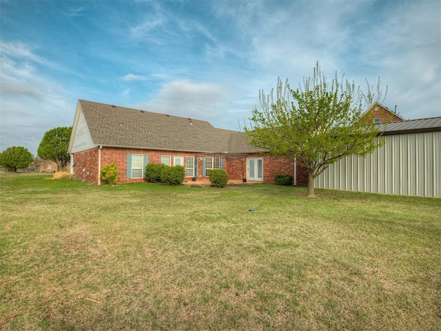 view of front of home with brick siding and a front yard