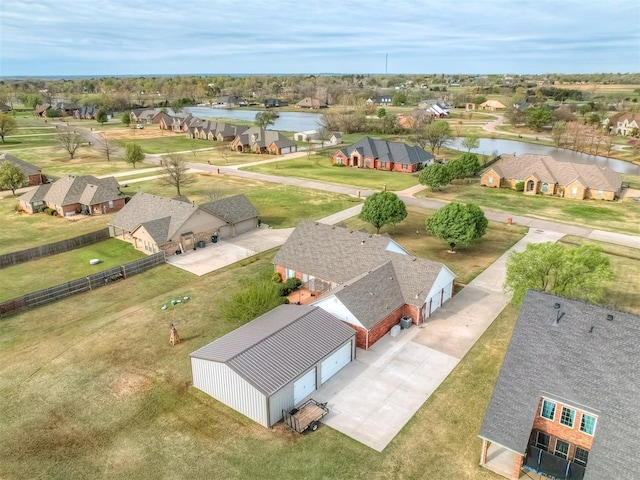 bird's eye view with a water view and a residential view