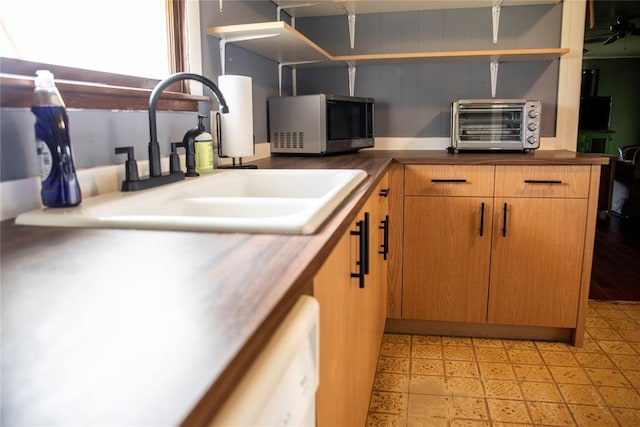 1011 W Mansur Ave, Guthrie, OK 73044 - kitchen with stainless steel microwave, open shelves, and light flooring