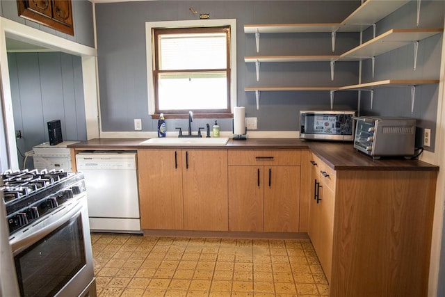 1011 W Mansur Ave, Guthrie, OK 73044 - kitchen featuring appliances with stainless steel finishes, dark countertops, light floors, and open shelves