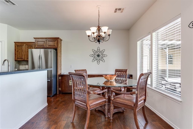 6574 Mint Julep Ln, Guthrie, OK 73044 - dining space with a chandelier, dark wood-style flooring, and healthy amount of natural light