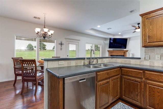 6574 Mint Julep Ln, Guthrie, OK 73044 - kitchen with stainless steel dishwasher, dark wood finished floors, dark countertops, a ceiling fan, and brown cabinetry