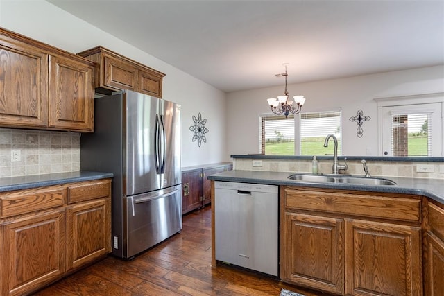 6574 Mint Julep Ln, Guthrie, OK 73044 - kitchen featuring stainless steel appliances, plenty of natural light, a chandelier, and brown cabinets