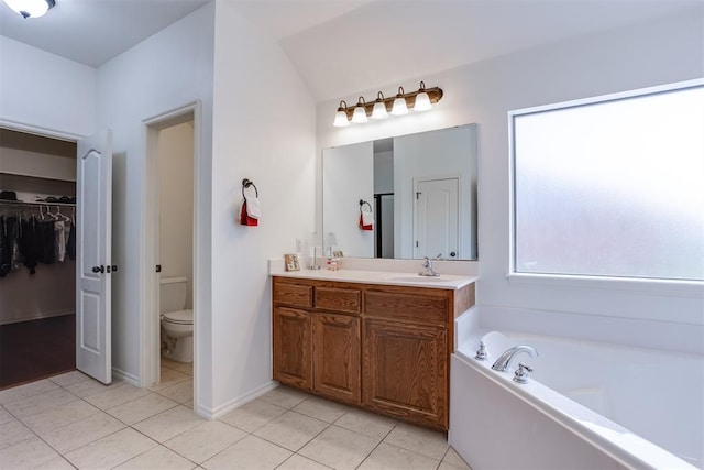 6574 Mint Julep Ln, Guthrie, OK 73044 - bathroom featuring tile patterned flooring, double vanity, a bath, a spacious closet, and vaulted ceiling
