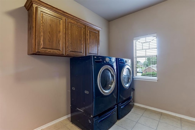 6574 Mint Julep Ln, Guthrie, OK 73044 - laundry area featuring independent washer and dryer, cabinet space, and light tile patterned floors