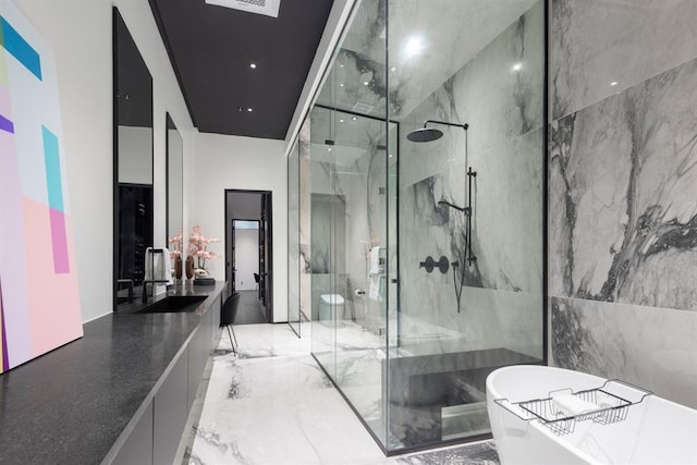 518 Colcord Dr, Oklahoma City, OK 73102 - bathroom with a soaking tub, marble finish floor, vanity, and a marble finish shower
