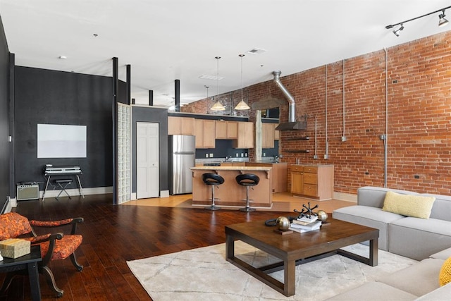 518 Colcord Dr, Oklahoma City, OK 73102 - living room featuring baseboards, visible vents, light wood-type flooring, and brick wall