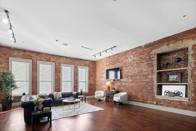518 Colcord Dr, Oklahoma City, OK 73102 - living room with hardwood / wood-style floors, brick wall, and a healthy amount of sunlight