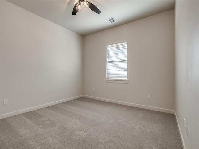 unfurnished room with carpet floors, baseboards, ceiling fan, and visible vents