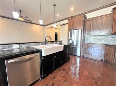 708 Kearny Ln, Yukon, OK 73099 - kitchen featuring appliances with stainless steel finishes, decorative backsplash, a ceiling fan, decorative light fixtures, and crown molding