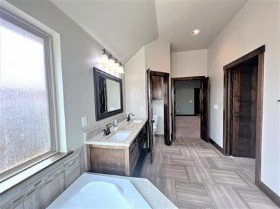 708 Kearny Ln, Yukon, OK 73099 - full bathroom featuring plenty of natural light, double vanity, lofted ceiling, and a bathtub