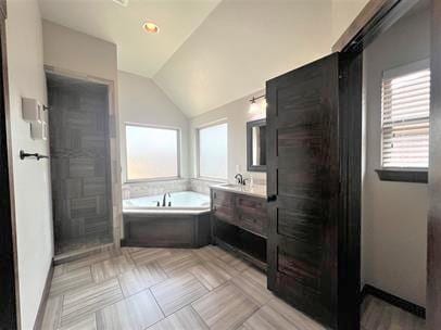 708 Kearny Ln, Yukon, OK 73099 - full bath featuring lofted ceiling, a garden tub, and vanity