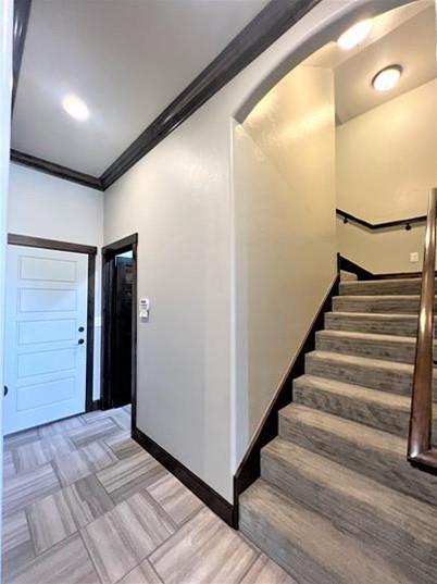708 Kearny Ln, Yukon, OK 73099 - foyer with crown molding, stairs, and arched walkways
