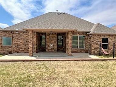 708 Kearny Ln, Yukon, OK 73099 - back of house featuring a patio area and a shingled roof