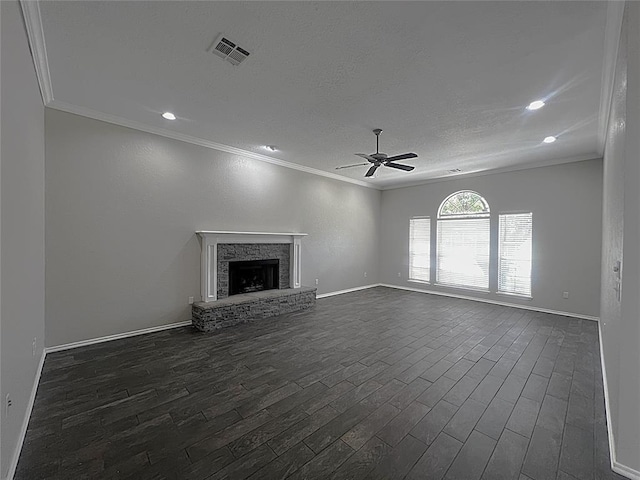 713 NW 143rd St, Edmond, OK 73013 - unfurnished living room featuring ceiling fan, crown molding, dark wood finished floors, a stone fireplace, and recessed lighting