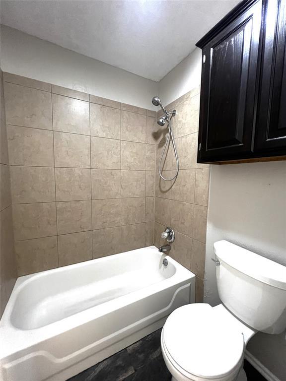 713 NW 143rd St, Edmond, OK 73013 - bathroom featuring shower / washtub combination and toilet