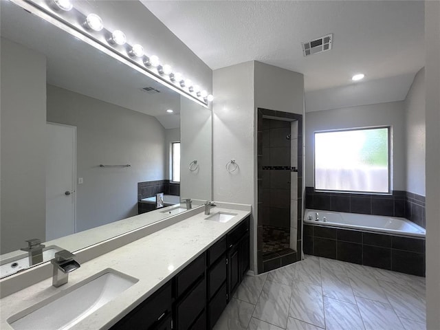 713 NW 143rd St, Edmond, OK 73013 - bathroom featuring a bath, double vanity, marble look tiles, and a tile shower