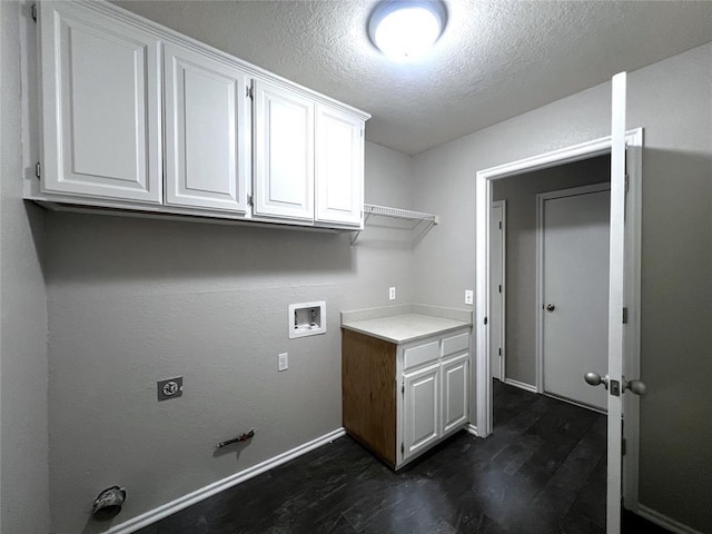 713 NW 143rd St, Edmond, OK 73013 - laundry area featuring dark wood-type flooring, hookup for a gas dryer, washer hookup, a textured ceiling, and cabinet space