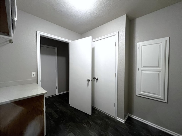 713 NW 143rd St, Edmond, OK 73013 - hallway with a textured ceiling and dark wood finished floors