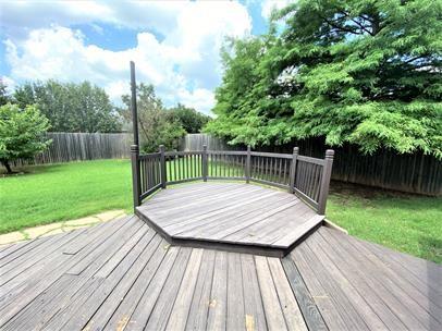 713 NW 143rd St, Edmond, OK 73013 - wooden terrace featuring a fenced backyard