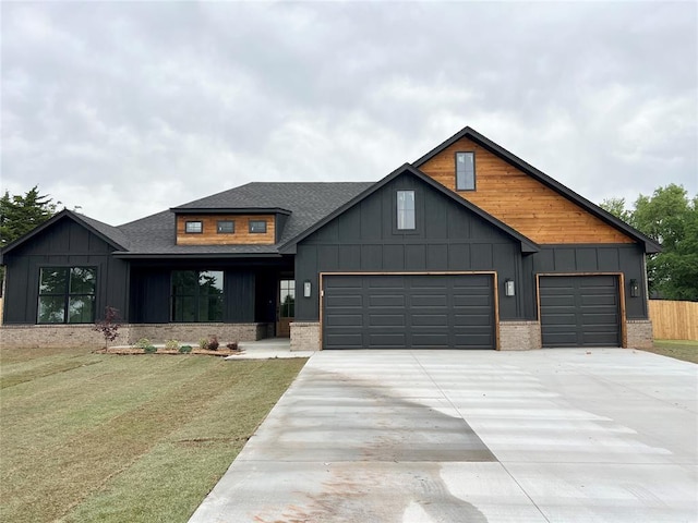 view of front of home featuring an attached garage, concrete driveway, a shingled roof, board and batten siding, and brick siding