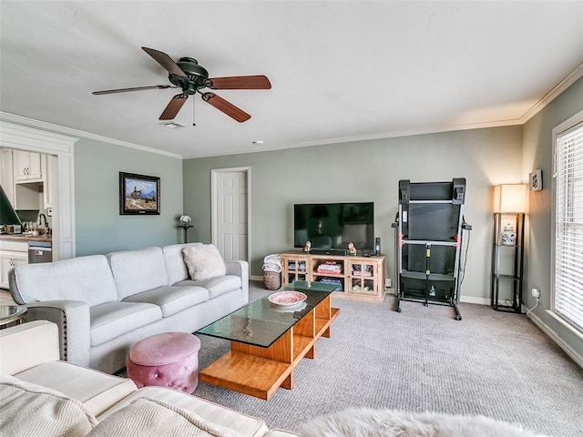 carpeted living area with ornamental molding, baseboards, a ceiling fan, and visible vents