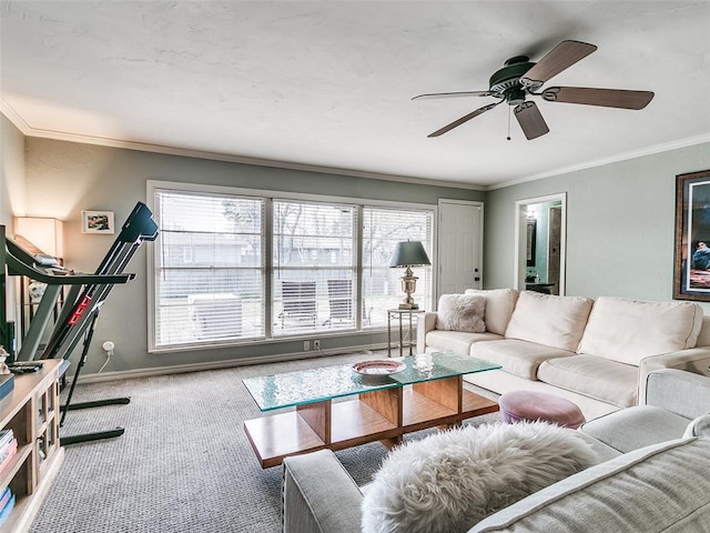 living room with carpet floors, crown molding, a ceiling fan, and a wealth of natural light