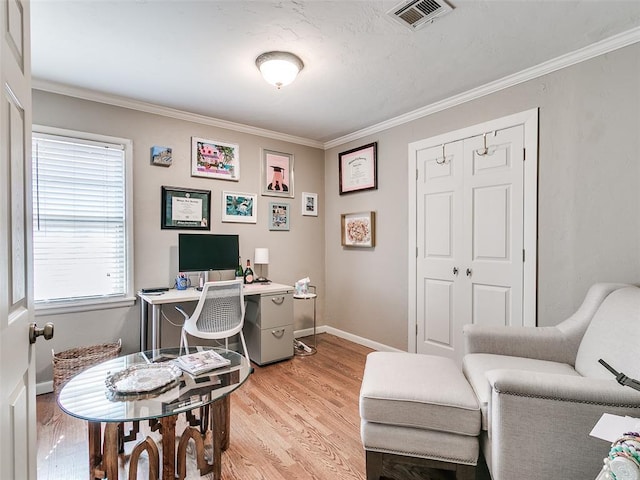 office area with ornamental molding, visible vents, light wood-style flooring, and baseboards