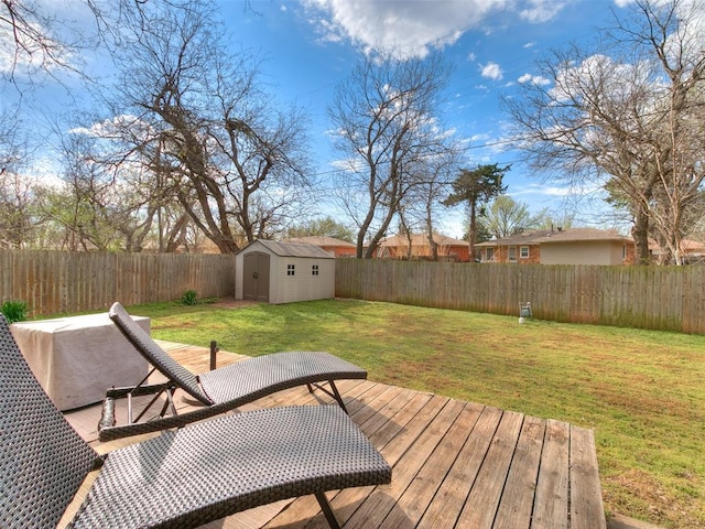 deck with a storage shed, a fenced backyard, an outdoor structure, and a lawn