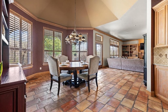 2817 Sweetbriar Way, Edmond, OK 73034 - dining area featuring a chandelier, baseboards, ornamental molding, and lofted ceiling