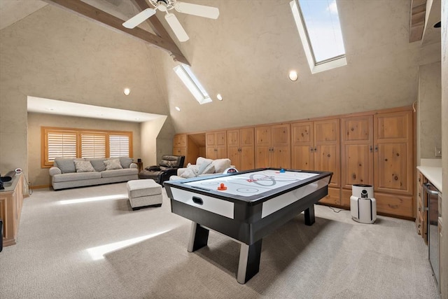 2817 Sweetbriar Way, Edmond, OK 73034 - playroom with a skylight, light colored carpet, beamed ceiling, a ceiling fan, and high vaulted ceiling