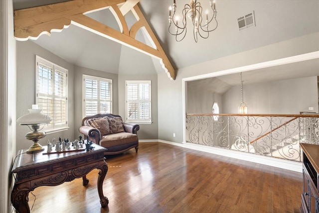 2817 Sweetbriar Way, Edmond, OK 73034 - living area featuring a chandelier, wood finished floors, healthy amount of natural light, high vaulted ceiling, and beam ceiling