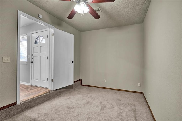 665 NW 15th St, Moore, OK 73160 - carpeted empty room with ceiling fan, a textured ceiling, and a textured wall