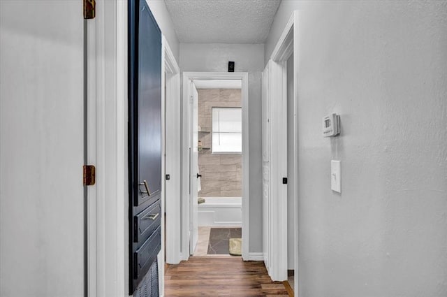 665 NW 15th St, Moore, OK 73160 - corridor featuring a textured ceiling and dark wood-style floors