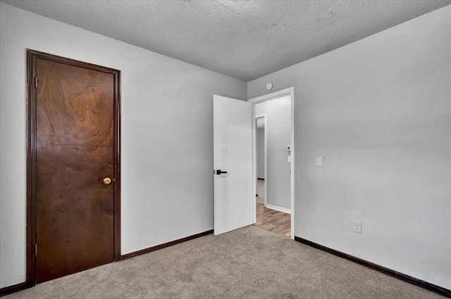 665 NW 15th St, Moore, OK 73160 - unfurnished bedroom with carpet flooring and a textured ceiling