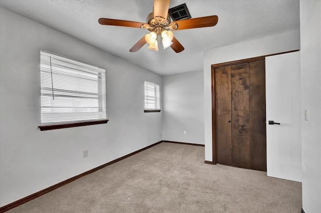 665 NW 15th St, Moore, OK 73160 - unfurnished bedroom featuring carpet, a closet, a ceiling fan, and a textured ceiling