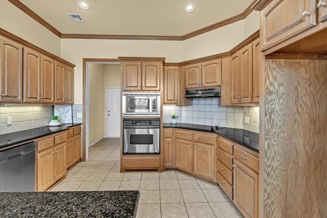 5405 NW 122nd Ter, Oklahoma City, OK 73162 - kitchen with appliances with stainless steel finishes, ornamental molding, light tile patterned floors, decorative backsplash, and under cabinet range hood