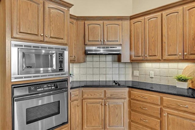 5405 NW 122nd Ter, Oklahoma City, OK 73162 - kitchen featuring stainless steel appliances, ventilation hood, backsplash, and dark stone counters