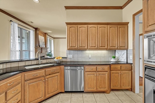 5405 NW 122nd Ter, Oklahoma City, OK 73162 - kitchen with appliances with stainless steel finishes, a sink, ornamental molding, decorative backsplash, and dark stone countertops