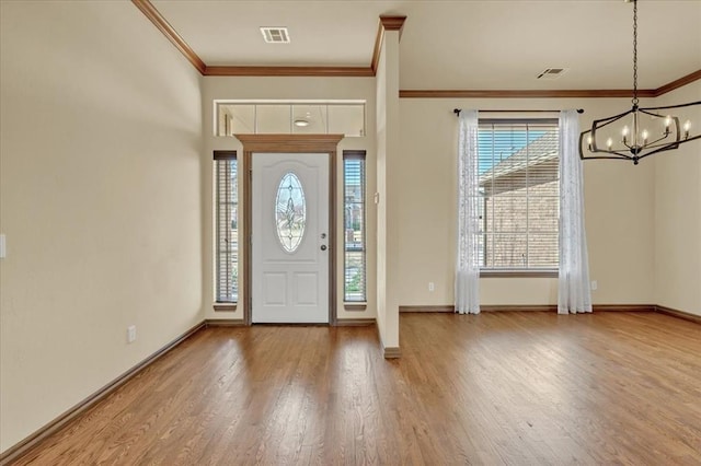 5405 NW 122nd Ter, Oklahoma City, OK 73162 - foyer entrance with crown molding, a chandelier, wood finished floors, and baseboards