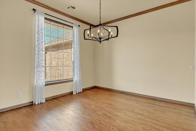 5405 NW 122nd Ter, Oklahoma City, OK 73162 - spare room with a chandelier, light wood finished floors, crown molding, baseboards, and healthy amount of natural light