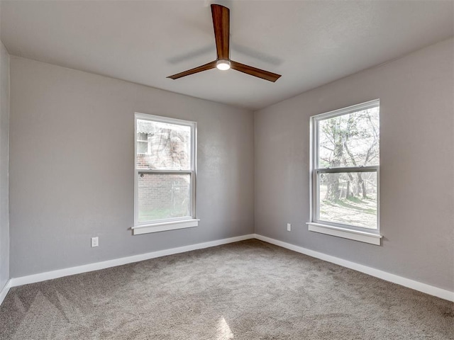 unfurnished room featuring carpet flooring, baseboards, and ceiling fan