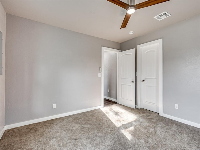 unfurnished bedroom with baseboards, ceiling fan, visible vents, and carpet