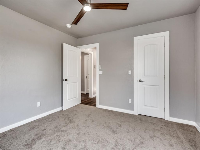 unfurnished bedroom featuring baseboards, carpet floors, and a ceiling fan