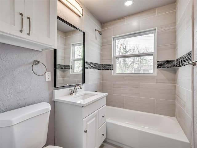 full bath featuring shower / bathing tub combination, vanity, recessed lighting, toilet, and a textured wall