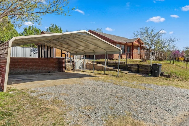 view of car parking featuring gravel driveway and a carport