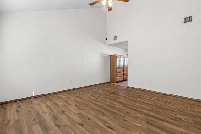 empty room featuring ceiling fan, visible vents, and wood finished floors