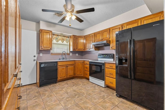 kitchen featuring light countertops, a ceiling fan, under cabinet range hood, a sink, and black appliances