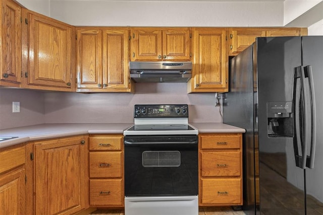 kitchen featuring light countertops, under cabinet range hood, electric range oven, black refrigerator with ice dispenser, and brown cabinetry