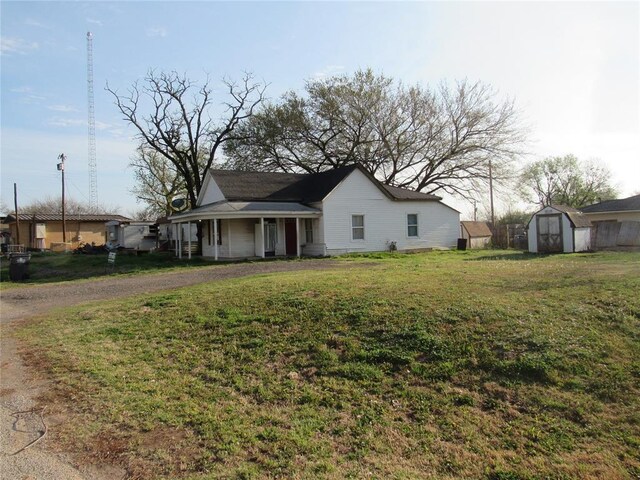 110 S Cherry, Paoli, OK 73074 - view of front facade with a front lawn, a shed, and an outbuilding